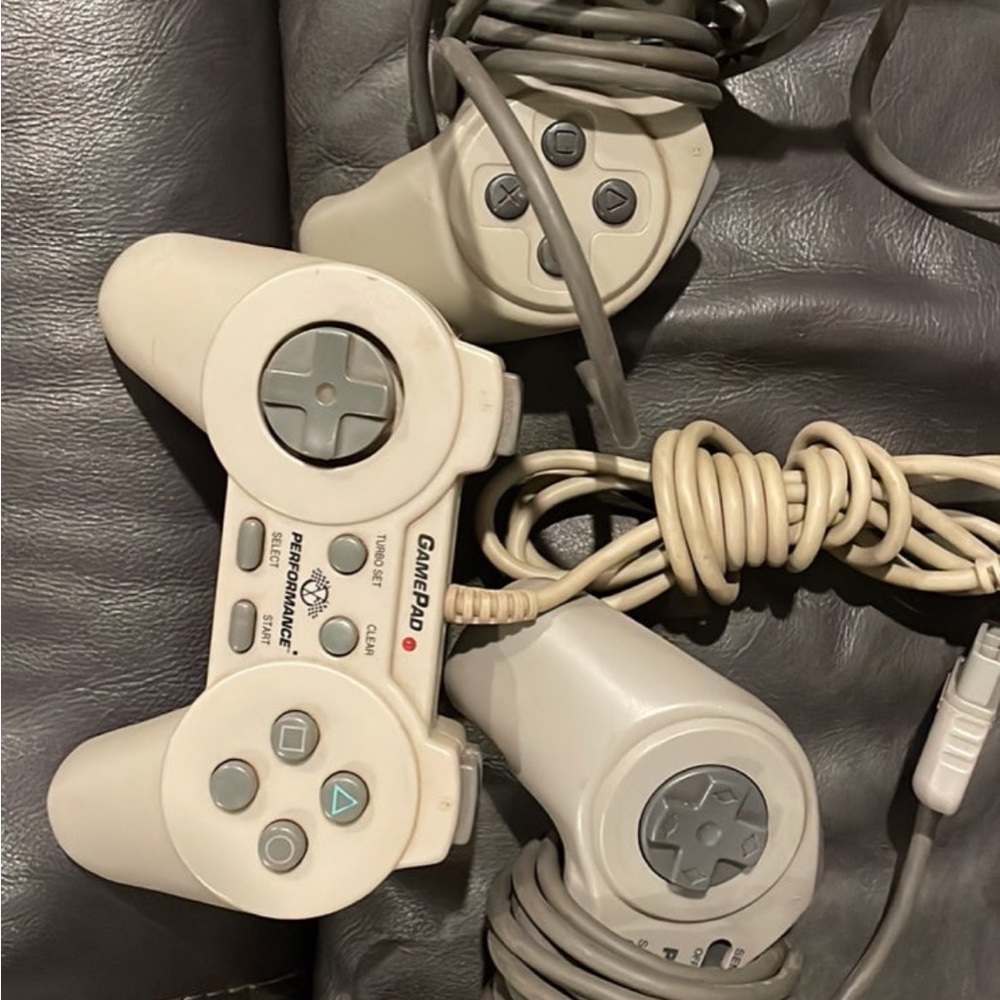 Three PlayStation Controllers